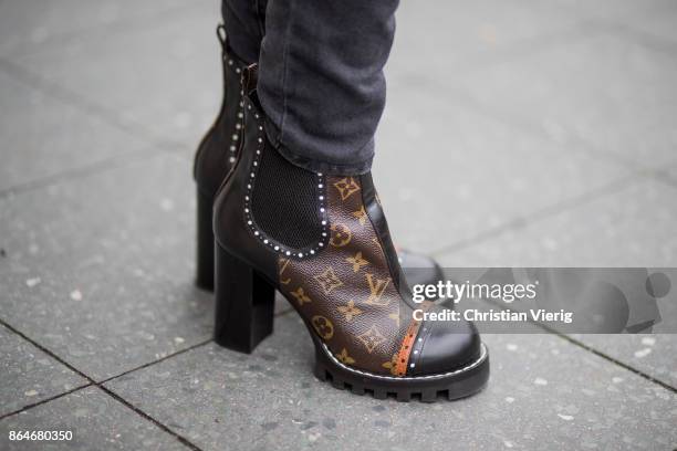 Miryam Labiad wearing Coach jacket, grey skinny jeans Current Elliot, Louis Vuitton boots on October 21, 2017 in Berlin, Germany.