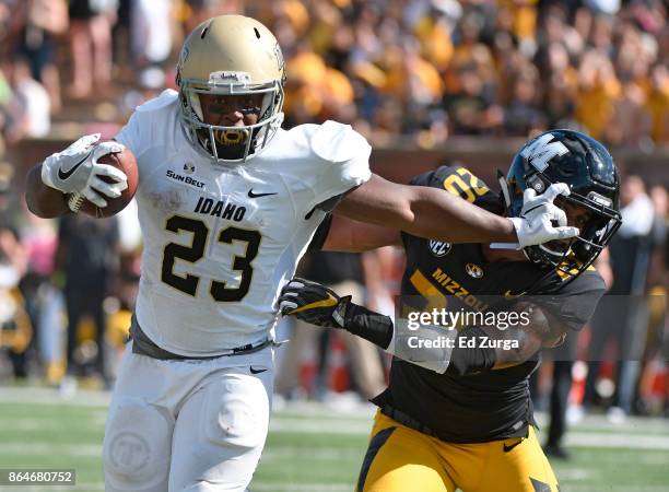 Aaron Duckworth of the Idaho Vandals stiff arms Kaleb Prewett of the Missouri Tigers as he tries to gains extra yards in the second quarter at...