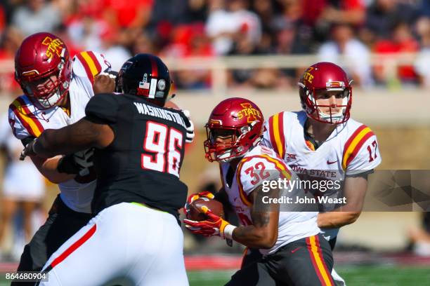 Kyle Kempt of the Iowa State Cyclones hans the ball off to David Montgomery of the Iowa State Cyclones during the game against the Texas Tech Red...