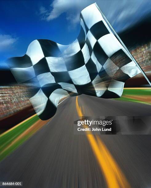 motor racing, chequered flag above track (digital composite) - zielflagge stock-fotos und bilder