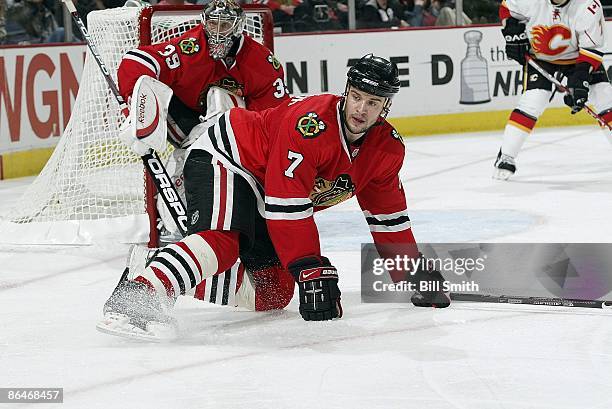 Brent Seabrook of the Chicago Blackhawks falls to the ice by Chicago's goal being guarded by Nikolai Khabibulin during game 5 of the Western...