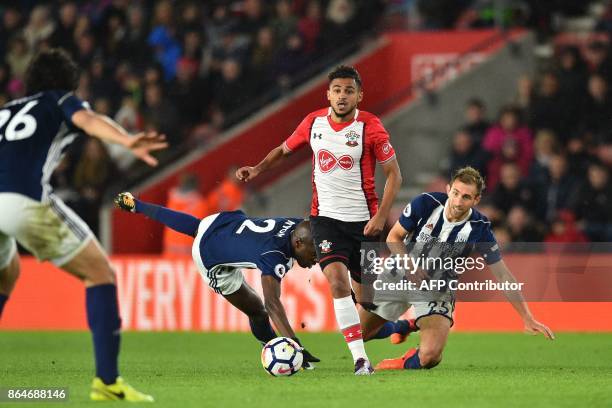 Southampton's Moroccan midfielder Sofiane Boufal runs past West Bromwich Albion's French-born Cameroonian defender Allan Nyom and West Bromwich...