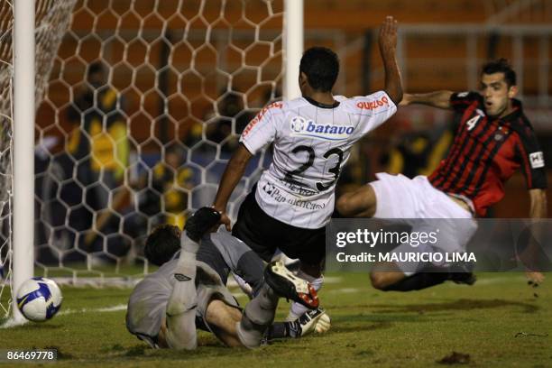 Jorge Henrique , of Corinthians, dribbles past goalkeeper Galatto , of Atletico Paranaense, but misses a goal opportunity, as Rhodolfo attempts to...