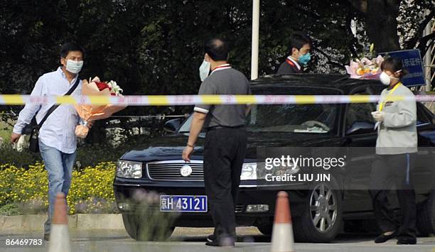 Chinese man walks to a car as he is released from a medical surveillance for influenza A at a sealed off hotel in Beijing on May 7 2009. China warned...