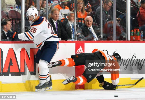 Darnell Nurse of the Edmonton Oilers upends Jori Lehtera of the Philadelphia Flyers at the Wells Fargo Center on October 21, 2017 in Philadelphia,...