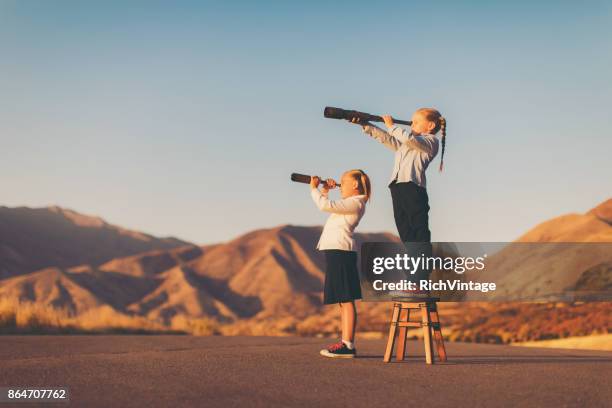 young business girl looks through telescope - girl power stock pictures, royalty-free photos & images