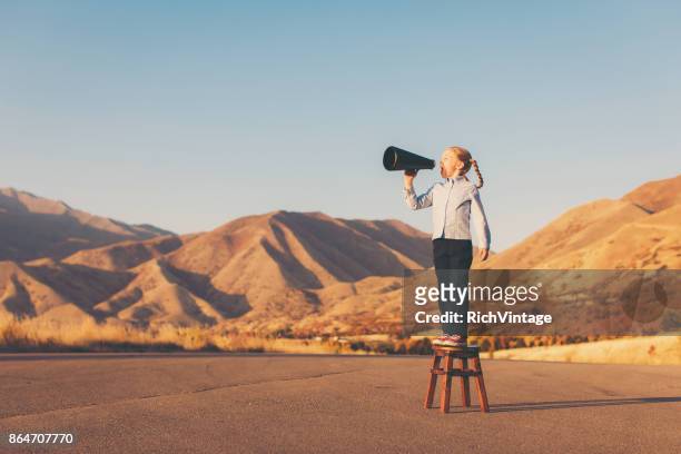 a young business girl uses megaphone - loudspeaker stock pictures, royalty-free photos & images