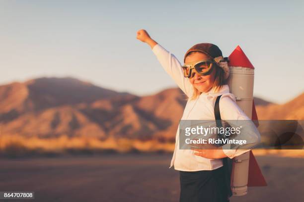 young business girl with rocket pack - dedication stock pictures, royalty-free photos & images