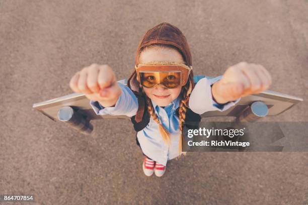 young business girl with jet pack raises arms - rocket pack stock pictures, royalty-free photos & images