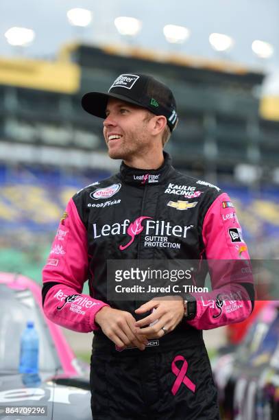 Blake Koch, driver of the Breast Cancer Honor & Remember Chevrolet, stands on the grid prior to the NASCAR XFINITY Series Kansas Lottery 300 at...