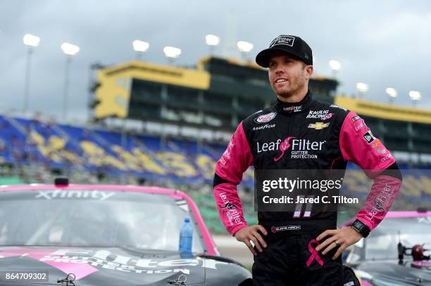 Blake Koch, driver of the Breast Cancer Honor & Remember Chevrolet, stands on the grid prior to the NASCAR XFINITY Series Kansas Lottery 300 at...