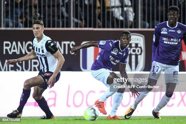 Toulouse's Brazilian midfielder Wergiton Somalia vies with Angers's Algerian defender Mehdi Tahrat and Toulouse's Ivory Coast midfielder Ibrahim...