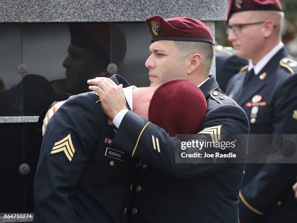 Members of the 3rd Special Forces Group 2nd battalion Fse comfort each other as they attend the burial service for U.S. Army Sgt. La David Johnson at...