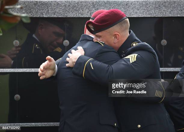 Members of the 3rd Special Forces Group 2nd battalion Fse comfort each other as they attend the burial service for U.S. Army Sgt. La David Johnson at...