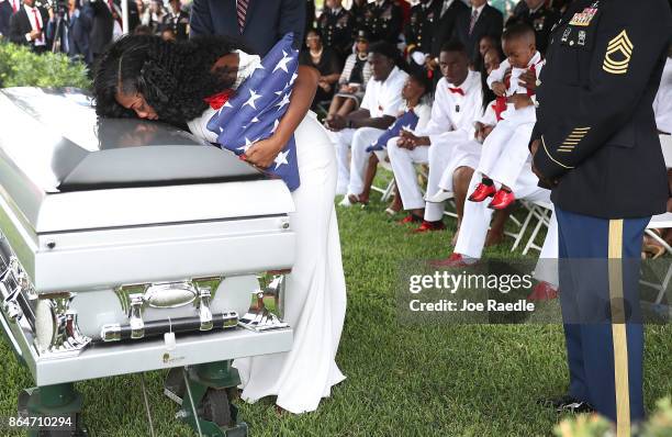 Myeshia Johnson kisses the casket of her husband U.S. Army Sgt. La David Johnson during his burial service at the Memorial Gardens East cemetery on...