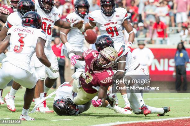 Running back Jacques Patrick of the Florida State Seminoles fumbles the ball at the goal line during their game against the Louisville Cardinals at...