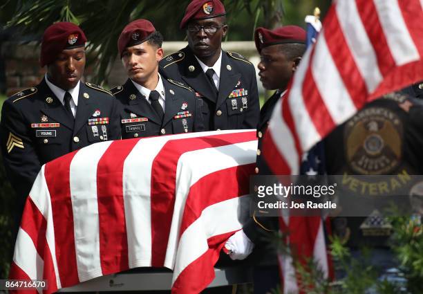 Military honor guards carry the casket of U.S. Army Sgt. La David Johnson during his burial service at the Memorial Gardens East cemetery on October...