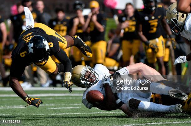 Jacob Sannon of the Idaho Vandals drops the ball for a incomplete pass as he is hit by Tavon Ross of the Missouri Tigers in the fourth quarter at...
