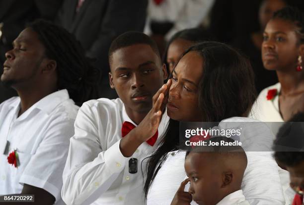 Richard Johnson, jr wipes tears away from the face of Cowanda Jones-Johnson as they attend the burial service for her son U.S. Army Sgt. La David...