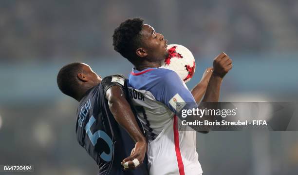 Ayo Akinola of the United States jumps for a header with Marc Guehi of England during the FIFA U-17 World Cup India 2017 Quarter Final match between...