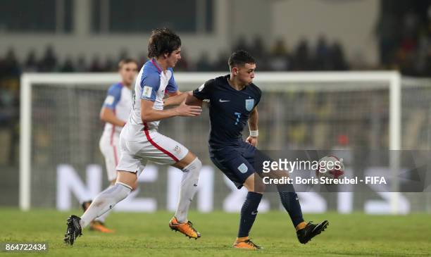 Taylor Booth of the United States challenges Philip Foden of England during the FIFA U-17 World Cup India 2017 Quarter Final match between USA and...