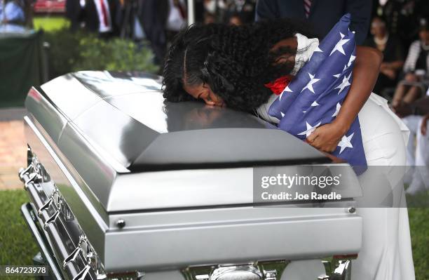 Myeshia Johnson kisses the casket of her husband U.S. Army Sgt. La David Johnson during his burial service at the Memorial Gardens East cemetery on...