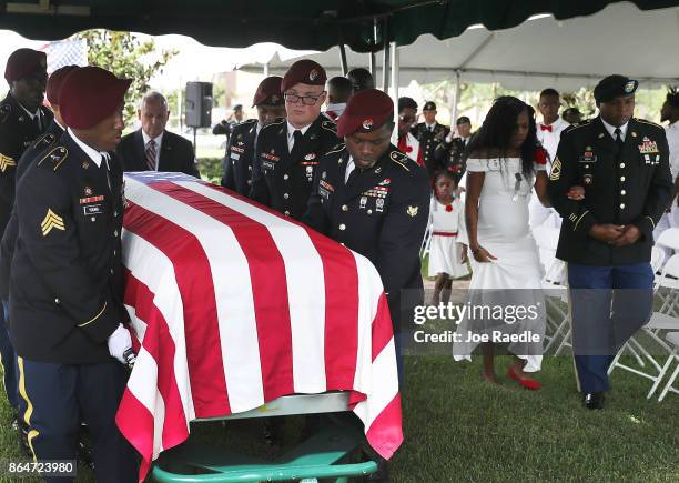 Myeshia Johnson is escorted to her seat as a Military Honor Guard carries the casket of her husband U.S. Army Sgt. La David Johnson during his burial...