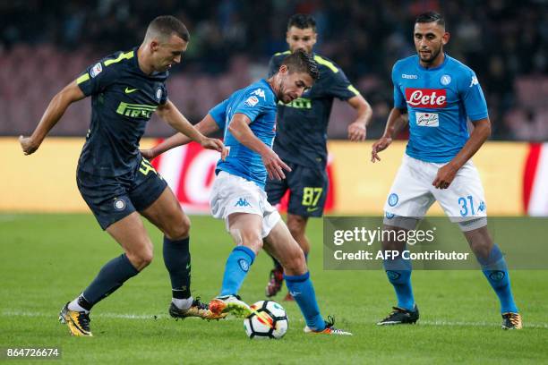 Napoli's Italian midfielder Brazilian-born Jorginho controls the ball as fighting with Inter Milan's Croatian midfielder Ivan Perisic next to teammat...