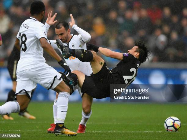 Leon Britton of Swansea fouls Shinji Okazaki of Leicester during the Premier League match between Swansea City and Leicester City at Liberty Stadium...