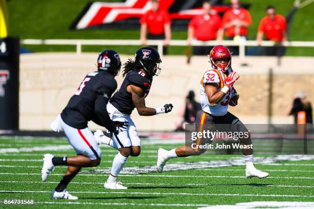 David Montgomery of the Iowa State Cyclones tries to outrun the Texas Tech Red Raider defenders during the game between the Texas Tech Red Raiders...