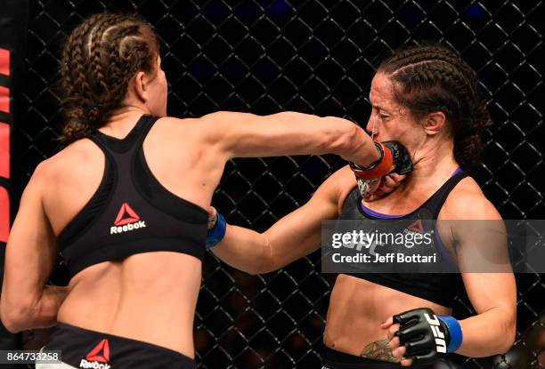 Karolina Kowalkiewicz of Poland punches Jodie Esquibel in their women's strawweight bout during the UFC Fight Night event inside Ergo Arena on...