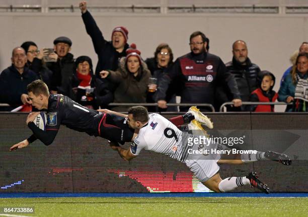 Liam Williams of Saracens scores a try despite the efforts of Thomas Habberfield of Ospreys during the European Rugby Champions Cup match between...