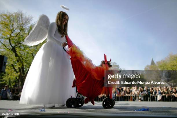 Woman and her dog in costumes attend the 27th Annual Tompkins Square Halloween Dog Parade in Tompkins Square Park on October 21, 2017 in New York...