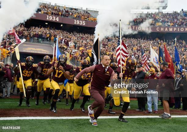 Head coach P.J. Fleck of the Minnesota Golden Gophers leads his team onto the field before the game against the Illinois Fighting Illini on October...