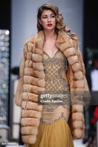 Model walks the runway at the Julia Dilua fashion show during day one of Mercedes Benz Fashion Week Russia S/S 2018 at Manege on October 21, 2017 in...