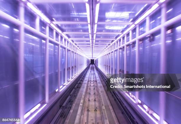 driver pov of a futuristic metro tunnel brightly illuminated as seen from an autonomous driverless metro - architecture symmetry stock-fotos und bilder