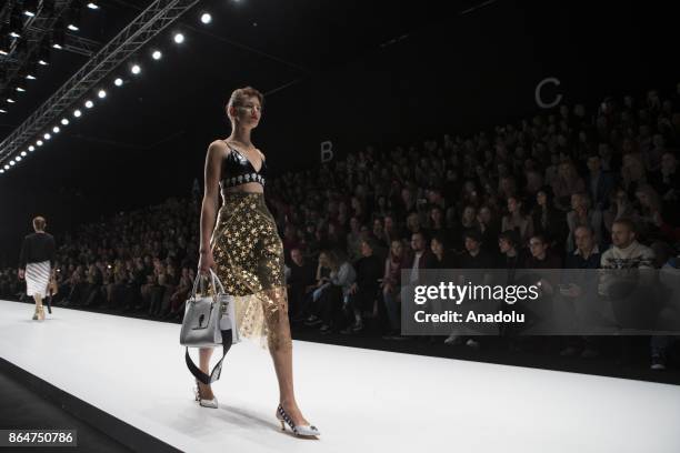 Model presents a creation by Bella Potemkina during the Mercedes-Benz Fashion Week Russia in Moscow, Russia on October 21, 2017.