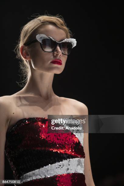 Model presents a creation by Bella Potemkina during the Mercedes-Benz Fashion Week Russia in Moscow, Russia on October 21, 2017.