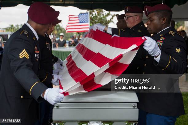 Pallbearers fold the flag draped over the casket of Sgt. La David Johnson during his burial service at Fred Hunter's Hollywood Memorial Gardens in...