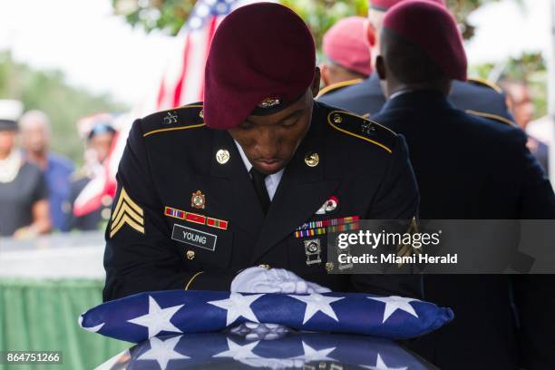 Sgt. Donald Young places a U.S. Flag over the casket of Sgt. La David Johnson during his burial service at Fred Hunter's Hollywood Memorial Gardens...