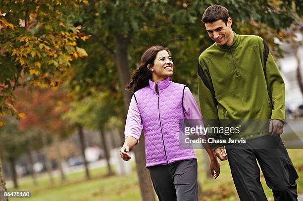 couple walking and socializing. - couple exercising 30s stock pictures, royalty-free photos & images