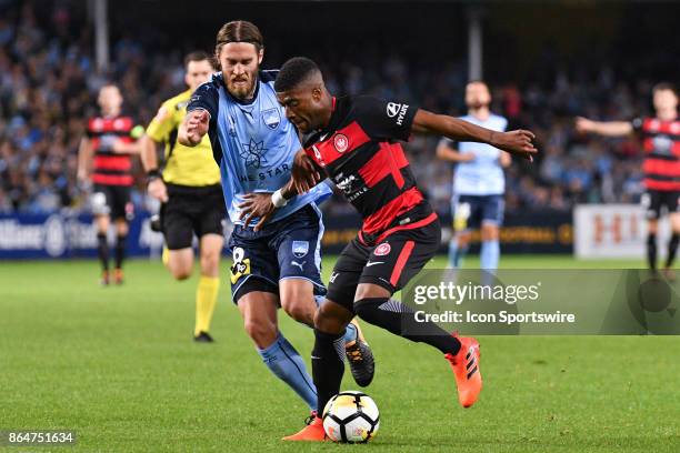 Western Sydney Wanderers midfielder Roly Bonevacia and Sydney FC midfielder Joshua Brillante fight for the ball at the Hyundai A-League match between...