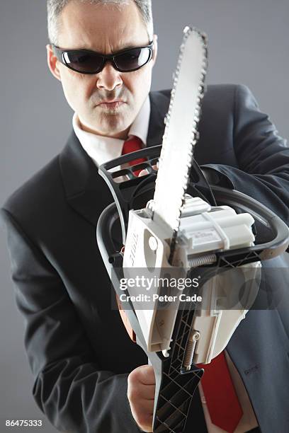 man in suit holding chainsaw - man with chainsaw stock pictures, royalty-free photos & images