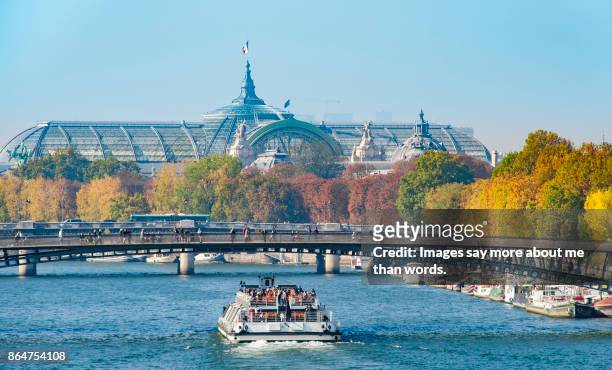 tour boat sailing the seine river on a beautiful fall day. - tour boat stock pictures, royalty-free photos & images