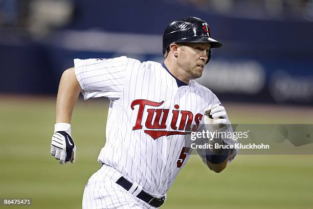 Michael Cuddyer of the Minnesota Twins runs to first on a double against the Los Angeles Angels in the third inning at the Metrodome on April 17,...