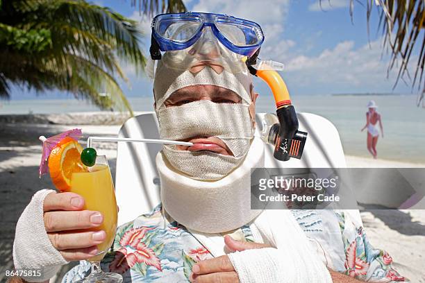 man in bandages on beach - cervical collar stock pictures, royalty-free photos & images