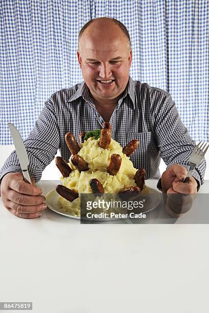 man eating very large plate of food - mashed potatoes stock pictures, royalty-free photos & images