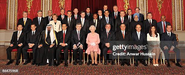 Queen Elizabeth II with delegates of the G20 London summit pose for a group picture in the Throne Room at Buckingham Palace on April 1, 2009 in...