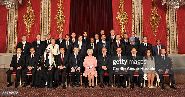 Queen Elizabeth II with delegates of the G20 London summit pose for a group picture in the Throne Room at Buckingham Palace on April 1, 2009 in...