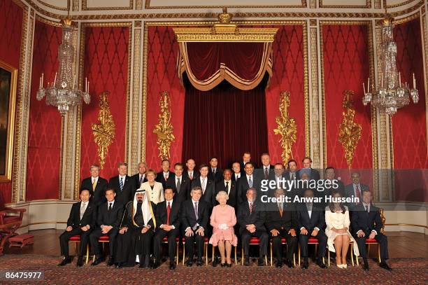 Queen Elizabeth II with delegates of the G20 London summit pose for a group picture in the Throne Room at Buckingham Palace on April 1, 2009 in...